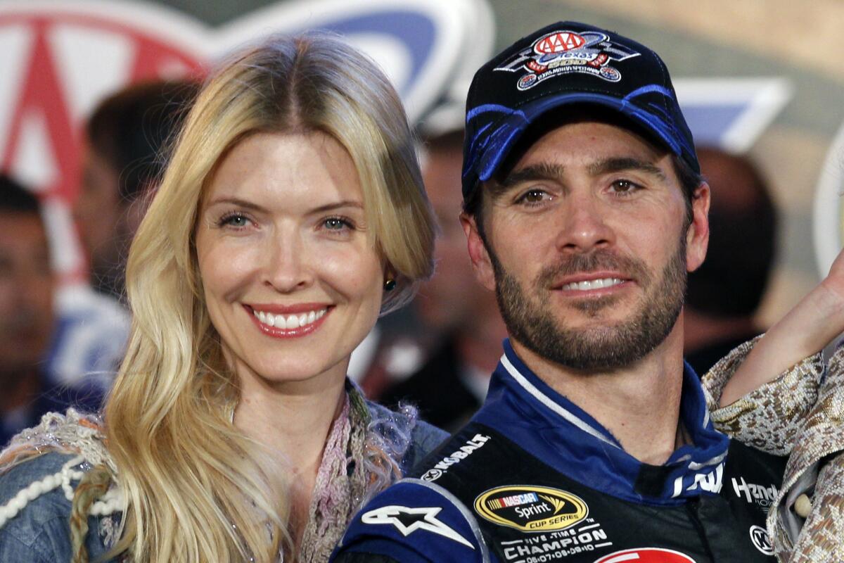 Legendary NASCAR driver Jimmie Johnson poses with his wife, Chandra Janway, for a photo at Texas Motor Speedway in 2012.