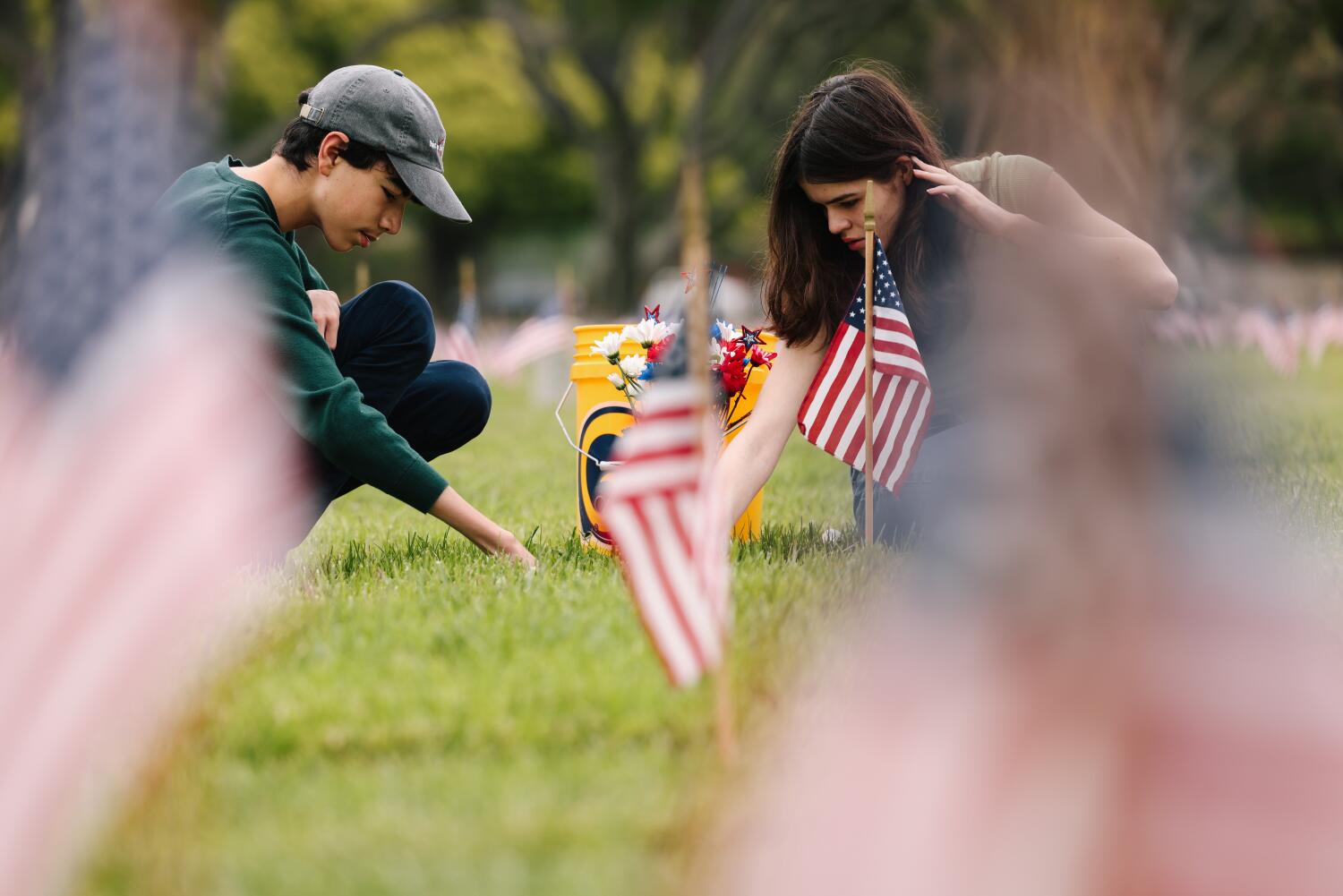 Loved ones attend to graves at Los Angeles National Cemetery ahead of Memorial Day