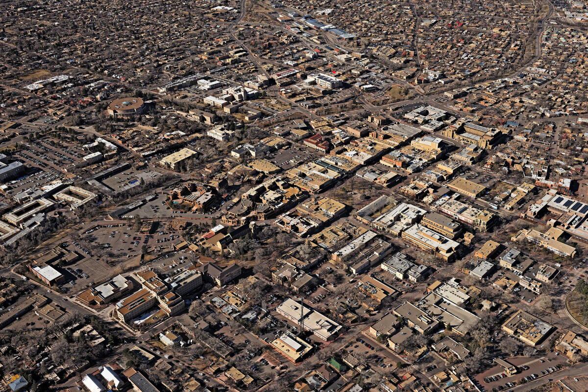 Oblique aerial view of the central downtown area of Santa Fe, looking southwest in late morning light. This view is an attempt to rephotograph the 1929 aerial photograph by Charles Lindbergh, negative number 130312.