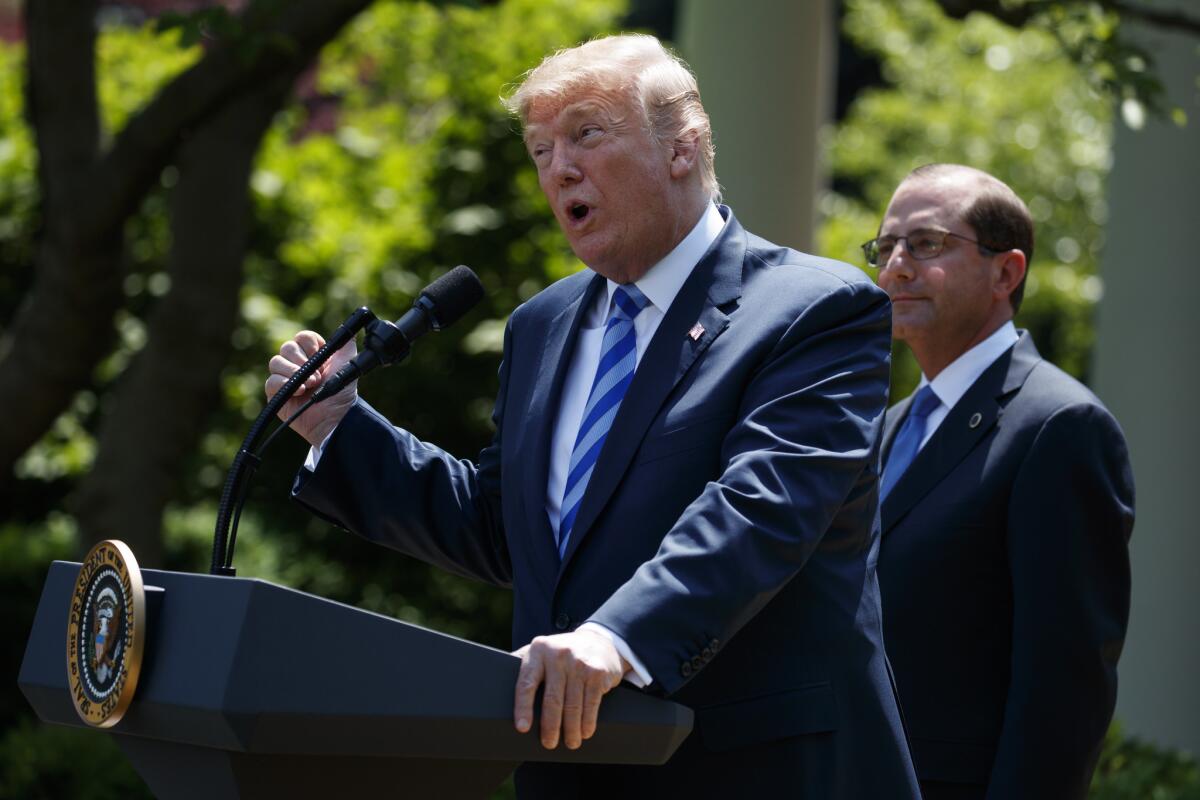 Health and Human Services Secretary Alex Azar looks on as President Trump speaks about drug prices at the White House Friday.