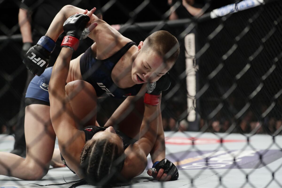 FKILE - Rose Namajunas, above, punches Joanna Jedrzejczyk, of Poland, during a women's strawweight title mixed martial arts bout at UFC 217 on Saturday, Nov. 4, 2017, at Madison Square Garden in New York. Namajunas used New York as her breakout city on her way toward UFC stardom. UFC 268 on Saturday Nov. 7, 2021, features two championship rematches. (AP Photo/Frank Franklin II, File)