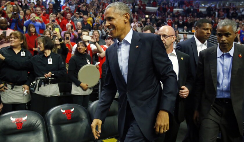 President Obama walks into the United Center during an NBA basketball game between the Cleveland Cavaliers and the Chicago Bulls in Chicago in October 2015.