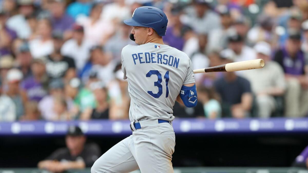 Dodgers left fielder Joc Pederson hits a two-run single during the sixth inning of a 10-5 victory over the Colorado Rockies on Sunday.