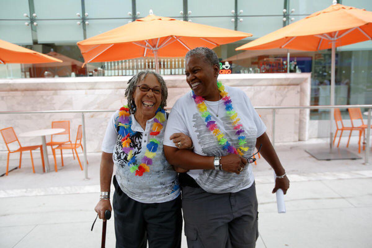 Lauryne Braithwaite, 65, left and Wanda Lawson, 63, wait for the shuttle bus after signing up to be married later in the day in West Hollywood.