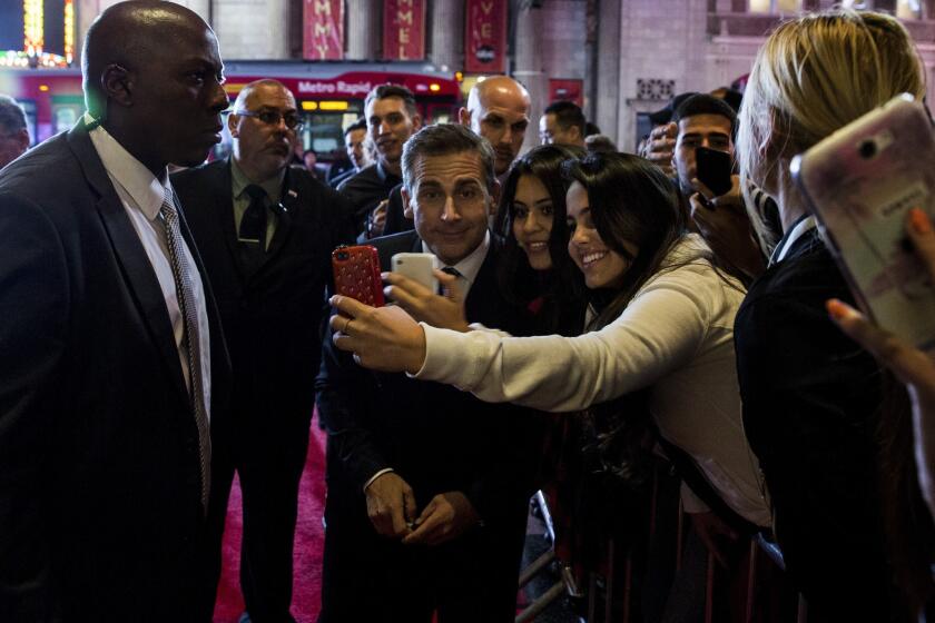 Steve Carell poses with fans.