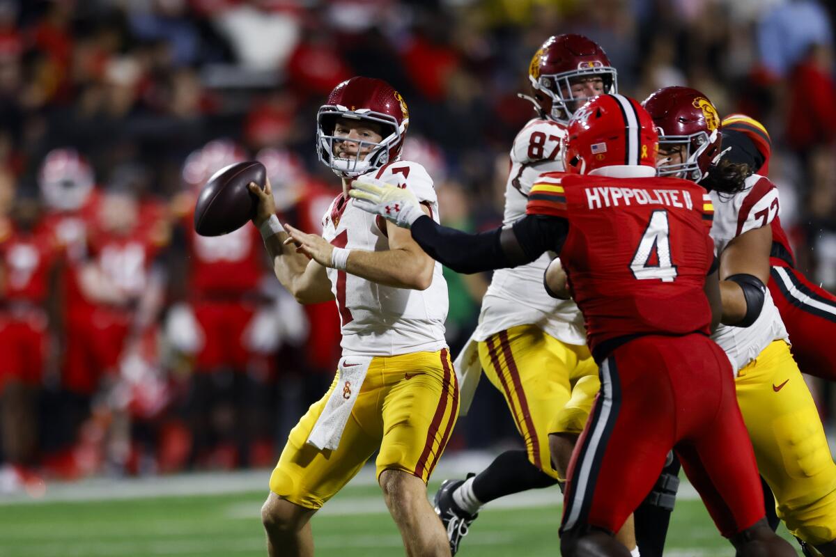 USC quarterback Miller Moss throws under pressure from Maryland linebacker Ruben Hyppolite II.