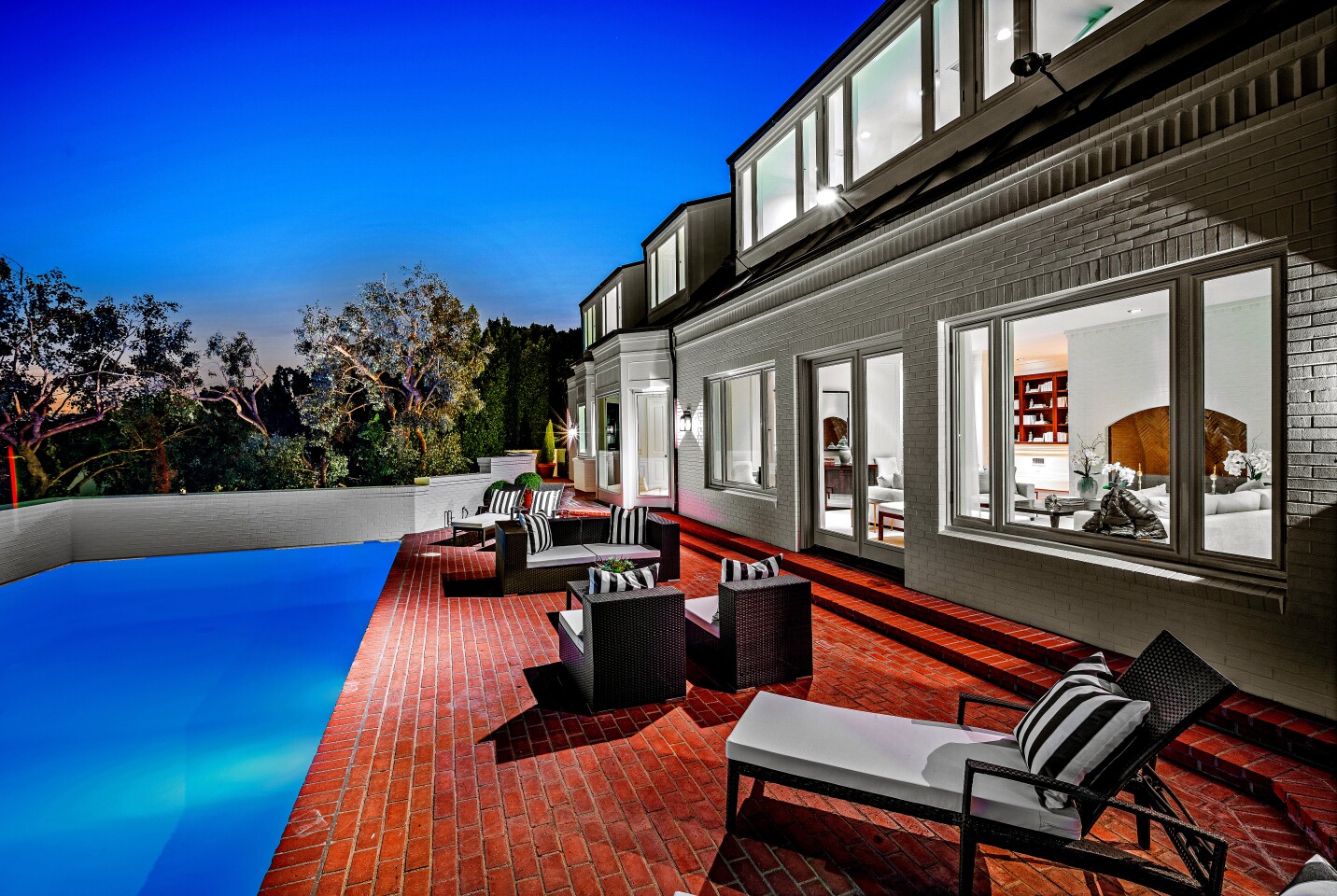 Sited below the Getty in Brentwood, the brick-clad residence was designed to evoke Denmark's traditional farmhouse architecture. Listed for $11.995 million, the Peter Chaote-designed house is reached by a winding drive that passes through a tunnel to reach the front motor court. The roughly two-third-acre property includes a greenhouse and a swimming pool. Expansive terraces center on views of the cityscape. The 7,958-square-foot house has a dual-island kitchen, a gym, four brick fireplaces, five bedrooms and 4.5 bathrooms.
