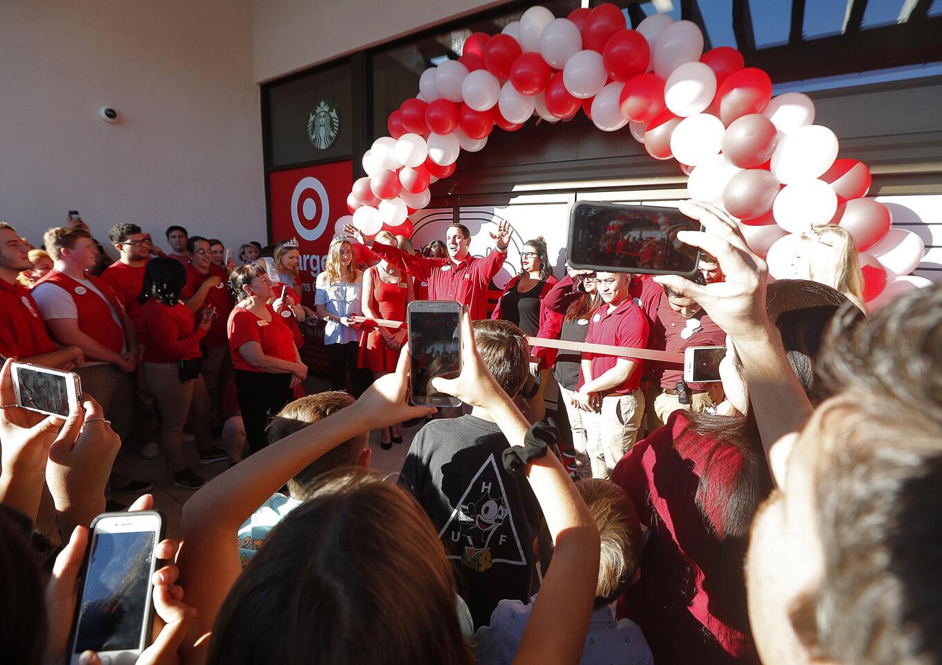 The Target store manager hails the crowd as he begins to introduce key people who helped open the store at a sneak-peek ribbon cutting to commemorate the grand opening of Target on Tuesday, October 16, 2018. Several city dignitaries, including the city council, State Senator Anthony Portantino, and leadership representatives gathered at the former Sport Chalet site to note the event.