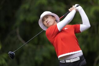 Amy Yang, of South Korea, watches her shot after hitting from the fourth tee.
