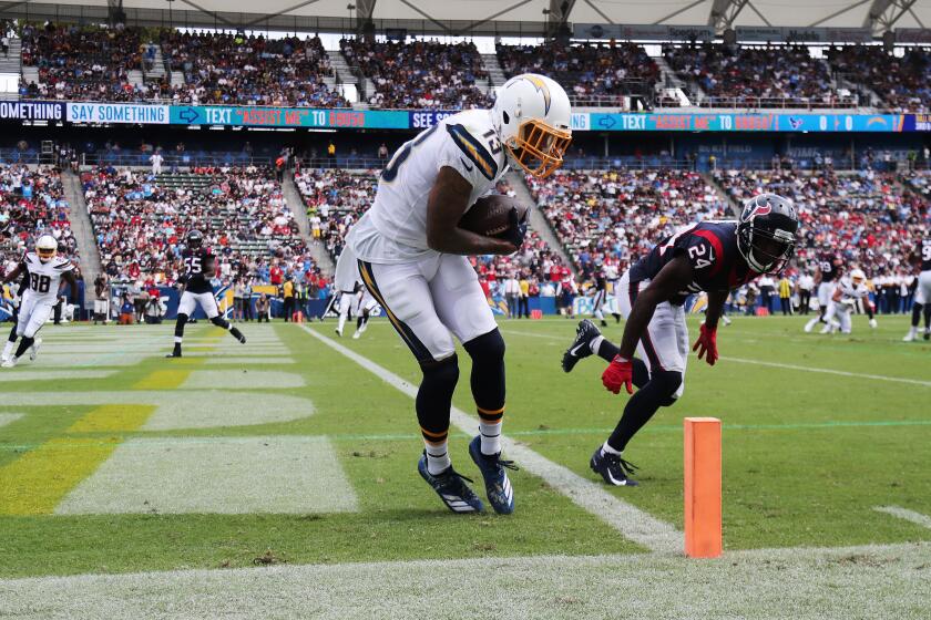 CARSON, CA - SEPTEMBER 22, 2019: Los Angeles Chargers wide receiver Keenan Allen (13) keeps his feet inbounds for a 7-yard touchdown pass against Houston Texans cornerback Johnathan Joseph (24) in the first quarter at Stub Hub Center on September 22, 2019 in Carson, California. (Gina Ferazzi/Los AngelesTimes)