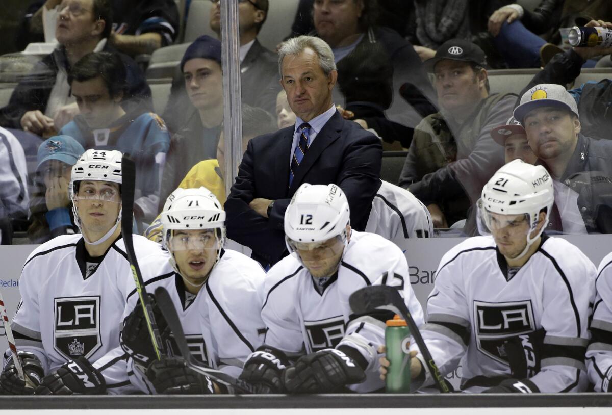 Coach Darryl Sutter stands behind the Kings bench during a game against the San Jose Sharks on Jan. 24.