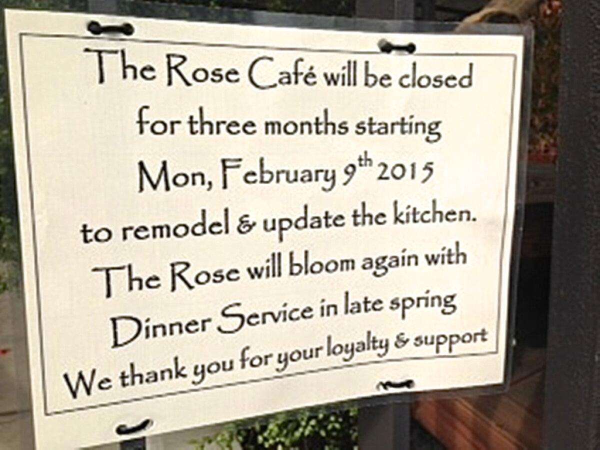 The sign in the front window announcing the closing of the Rose Cafe.