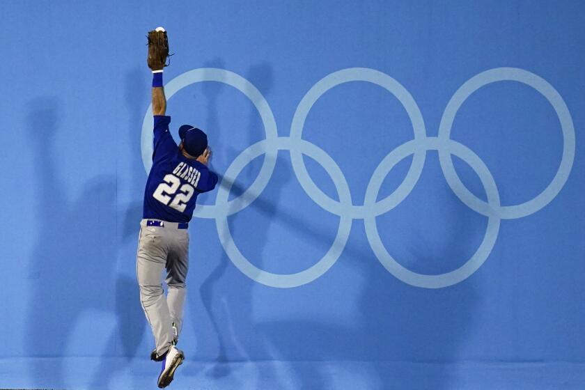Israel's Mitchell Glasser cannot reach a ball during a baseball game against South Korea at the 2020 Summer Olympics, Thursday, July 29, 2021, in Yokohama, Japan. (AP Photo/Sue Ogrocki)