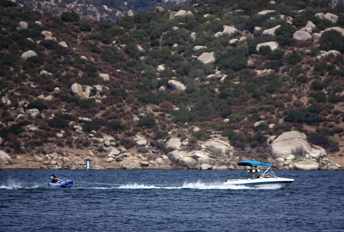 Boaters take to the water during a record-setting heat wave at San Vicente Reservoir.