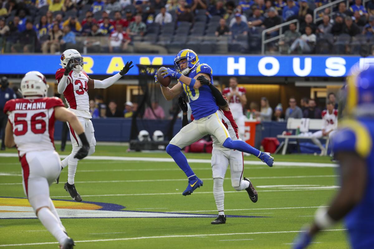 Rams' Cooper Kupp jumps to try to catch the ball