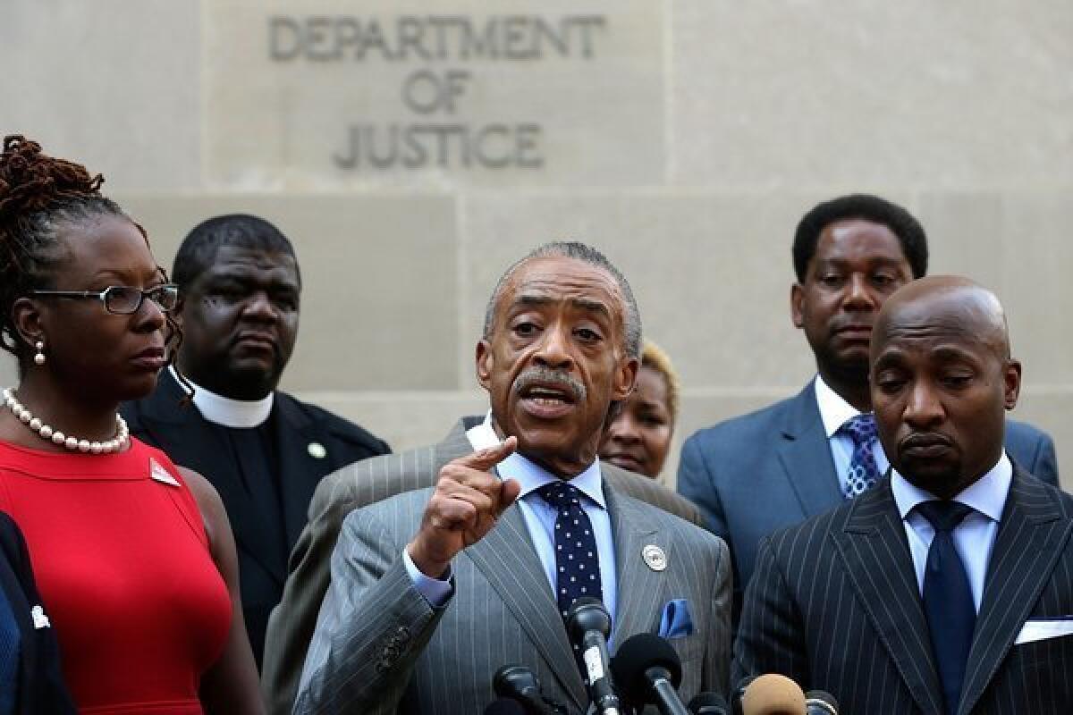 Rev. Al Sharpton speaks during a news conference outside the Department of Justice while discussing Trayvon Martin case. Sharpton called for the federal government to investigate civil rights charges against George Zimmerman.