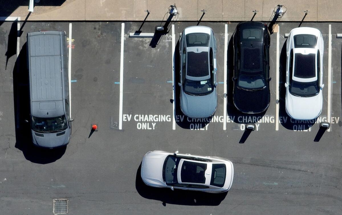 An electric car prepares to park at an EV charging station in Corte Madera.