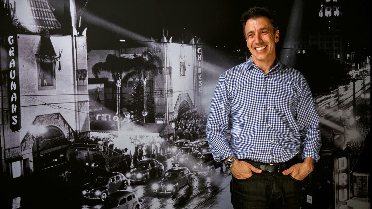 Fandango President Paul Yanover in front of a historical photo of the TCL Chinese Theatre, in Los Angeles, Calif.