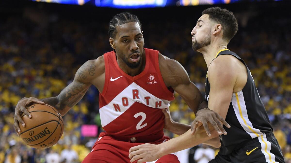 Toronto Raptors forward Kawhi Leonard, left, tries to drive past Golden State Warriors guard Klay Thompson during Game 6 of the NBA Finals. Will Leonard return to the Raptors?