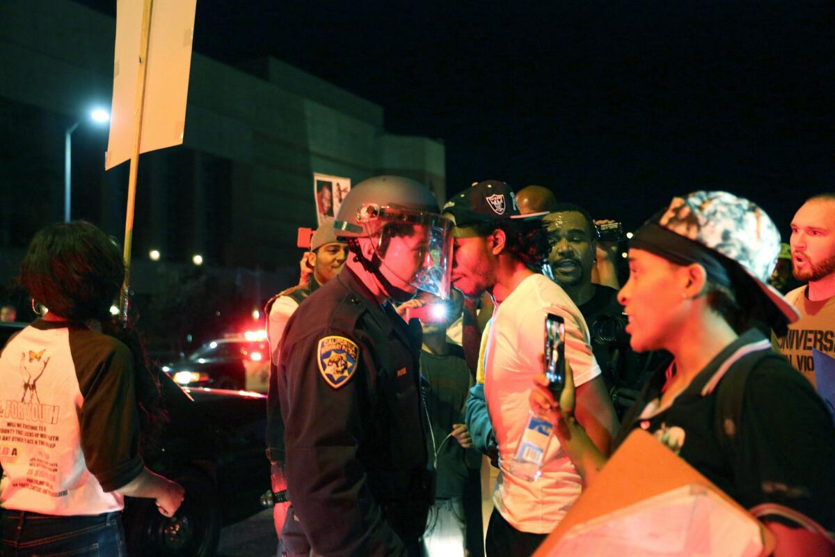 Protesters confront LAPD officers on Hope Street during the second day of protests.