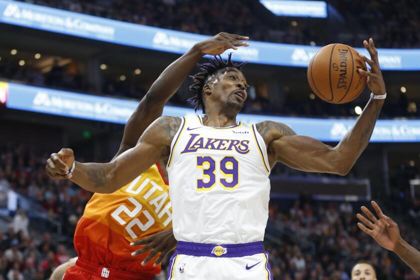 Los Angeles Lakers center Dwight Howard (39) pulls down a rebound as Utah Jazz forward Jeff Green (22) defends in the first half during an NBA basketball game Wednesday, Dec. 4, 2019, in Salt Lake City. (AP Photo/Rick Bowmer)