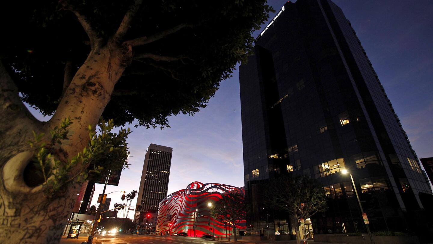 The Petersen Automotive Museum and its controversial facade glows at dawn in Los Angeles. The redesigned museum will be reopened to the public Saturday.