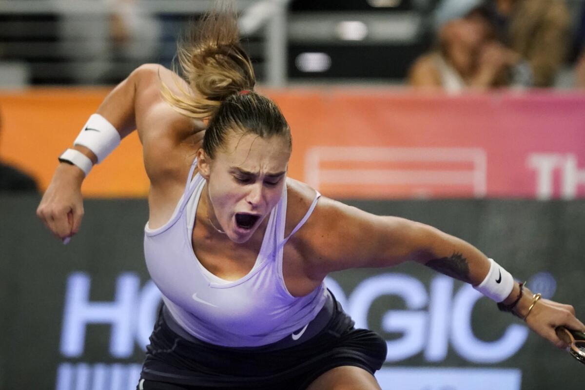 Aryna Sabalenka, of Belarus, reacts to winning the second set and match against Iga Swiatek, of Poland, in the singles semifinals of the WTA Finals tennis tournament in Fort Worth, Texas, Sunday, Nov. 6, 2022. (AP Photo/LM Otero)