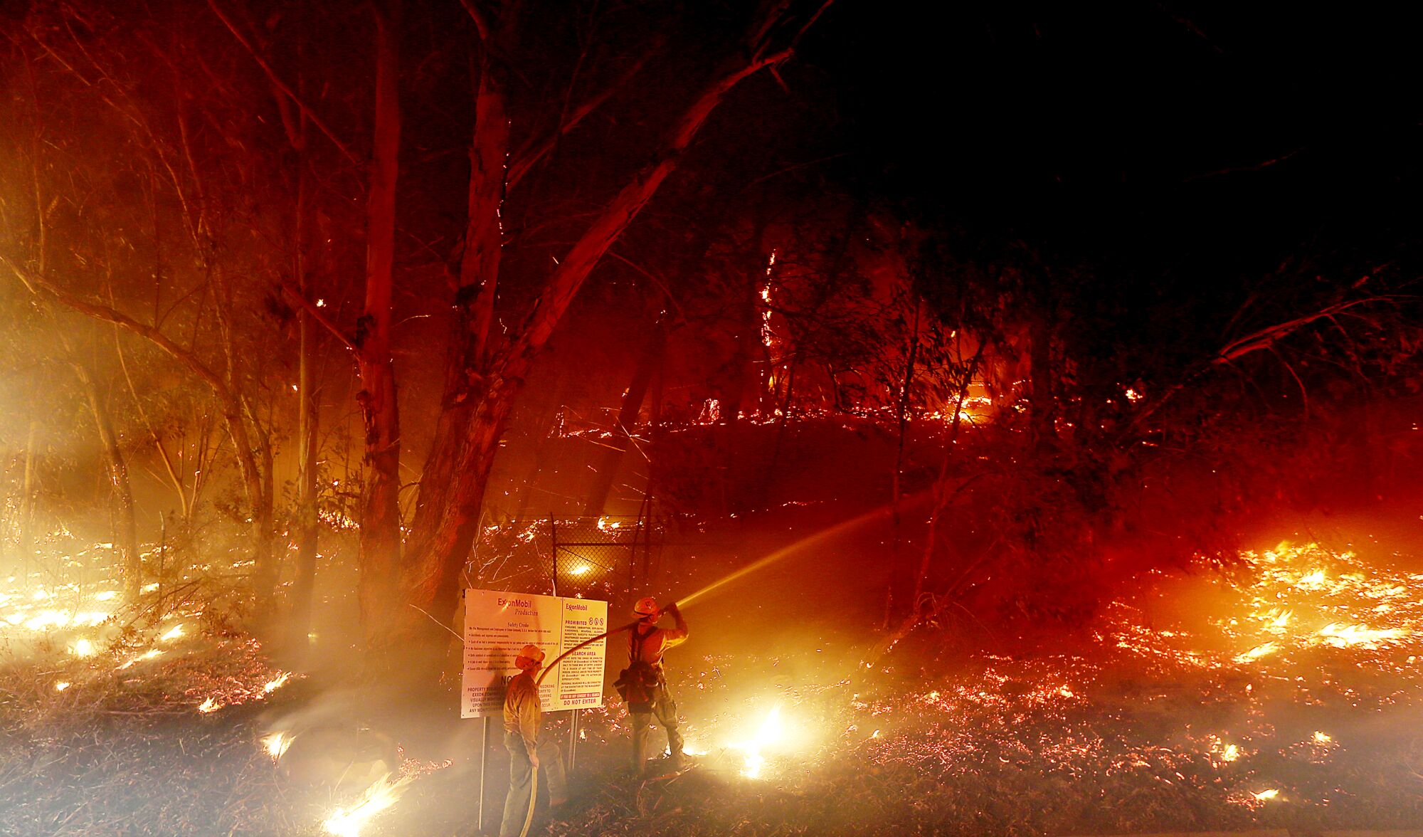 Firefighters battle the Alisal fire along the 101 Freeway near Goleta.