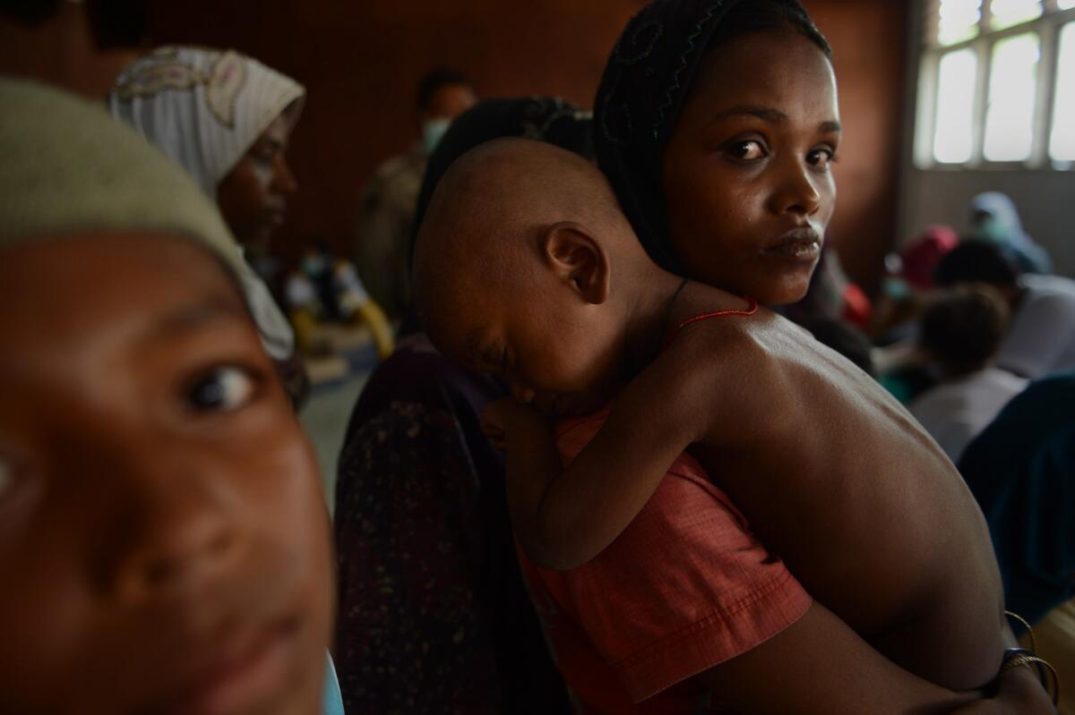 Women and children register at a confinement area for migrants in Indonesia after more than 400 Rohingya Muslims from Myanmar and Bangladesh were rescued by Indonesian fishermen on May 20.