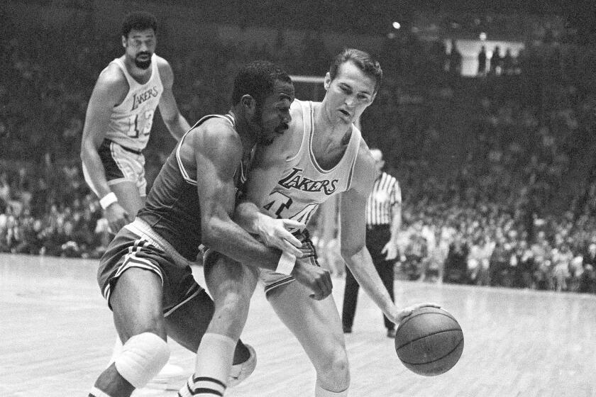 Lakers' Jerry West tries to take the ball down the court against Boston's Emmette Bryant during Game 1 of the 1969 NBA Finals