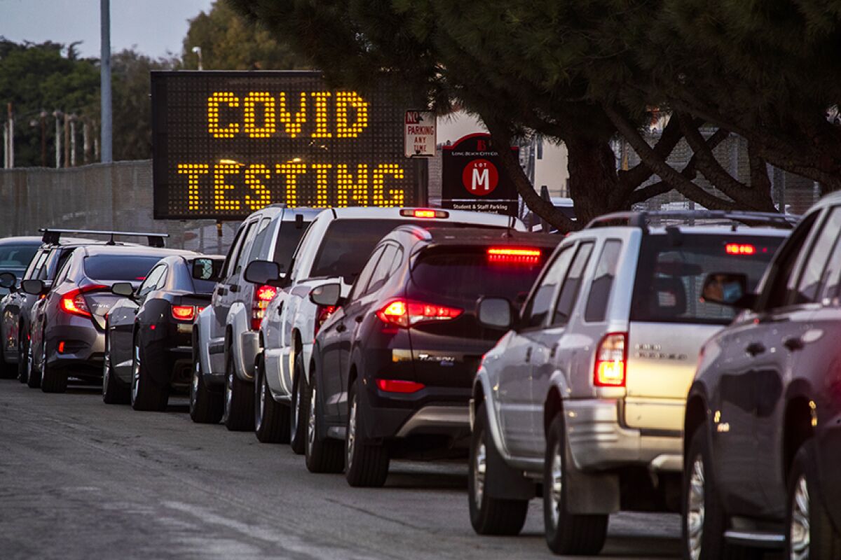 Motorists line up to take COVID-19 tests.