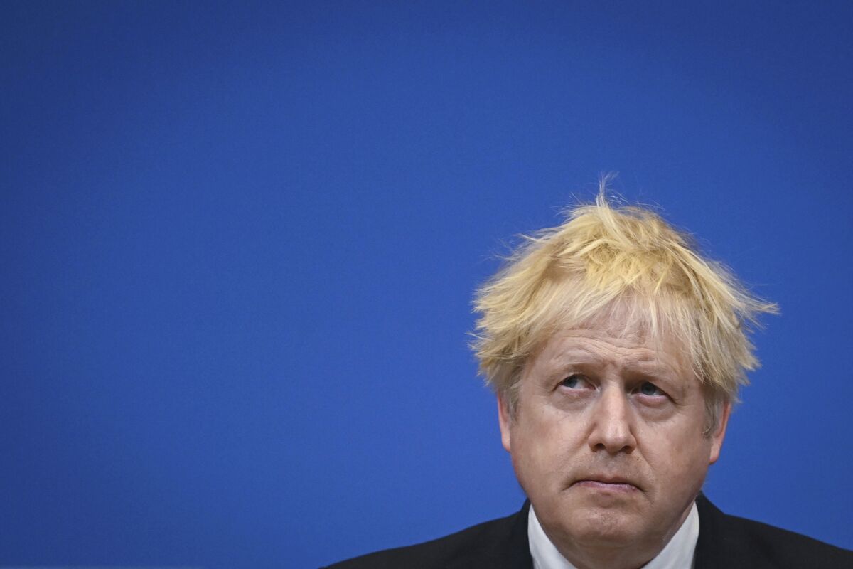 Britain's Prime Minister Boris Johnson pauses, during a joint press conference with NATO Secretary General Jens Stoltenberg, following a meeting at the NATO headquarters, in Brussels, Belgium, Thursday, Feb. 10, 2022. Johnson hasn't been able to escape his domestic woes during a trip to Belgium and Poland aimed at increasing pressure on Russia over its troop buildup near Ukraine. Johnson was trying show NATO’s resolve in response to Russia massing troops near its neighbor’s borders. But he faced questions about a police investigation into lockdown-breaching government parties that has shaken his grip on power. (Daniel Leal/Pool via AP)