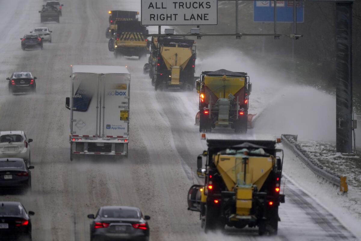 Vehicles navigate snow covered road