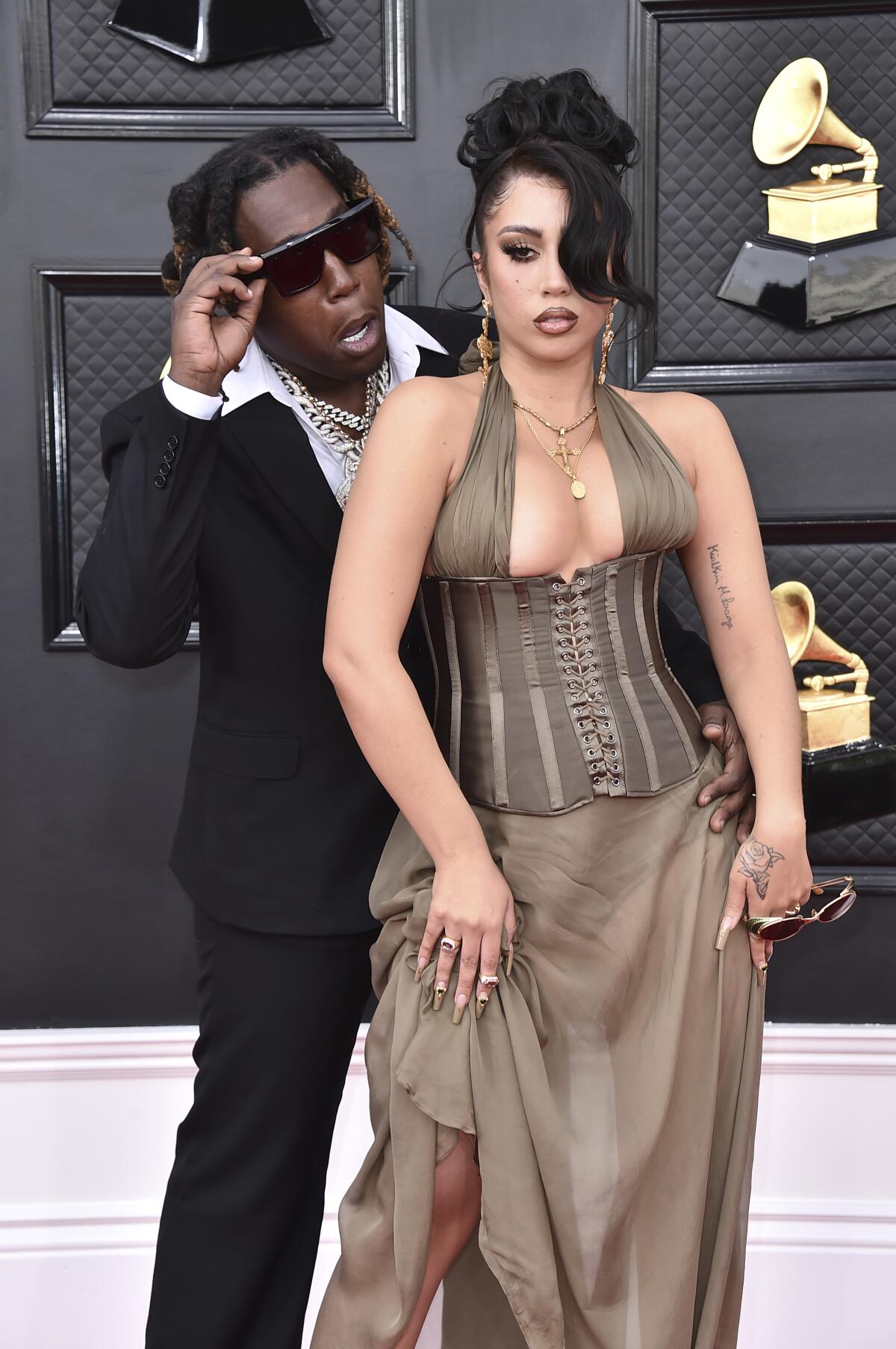 Don Toliver, left, and Kali Uchis arrive at the 64th Grammy Awards.