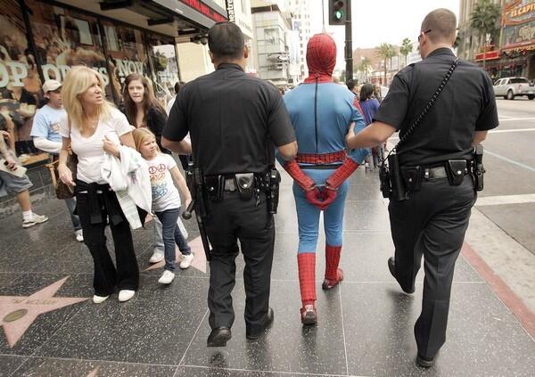 LAPD officers arrest a man in a Spider-Man outfit after he allegedly assaulted a man on Hollywood Boulevard in 2009.