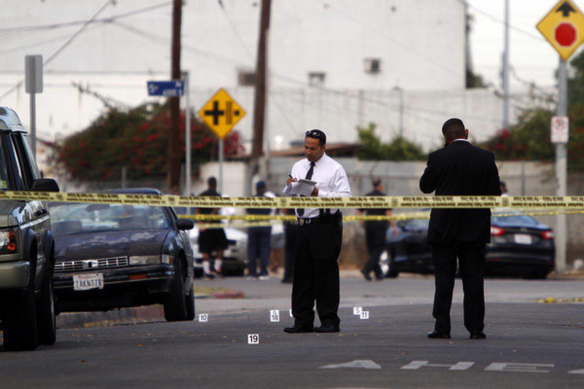 Police tape marks the area where two people were killed in a shooting Tuesday in South Los Angeles.