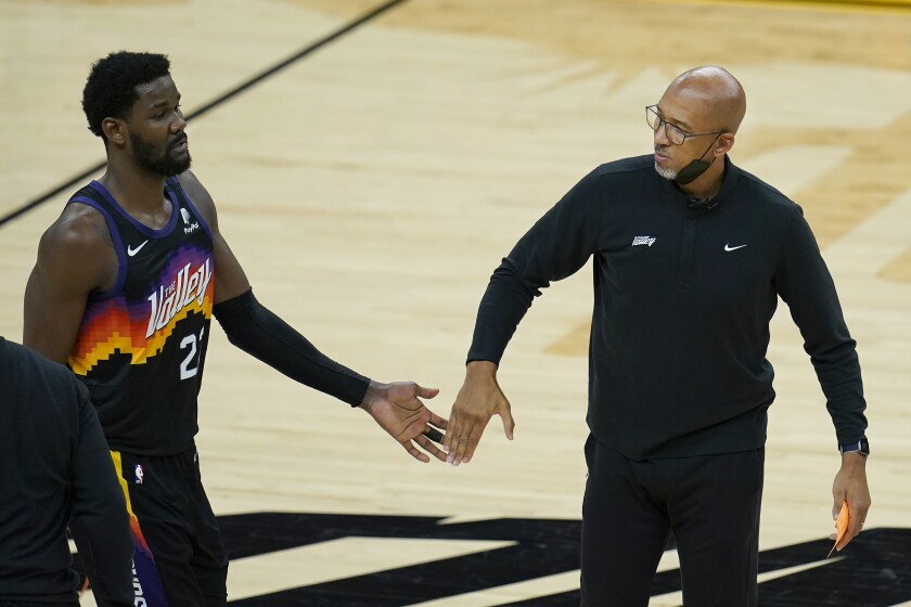 Phoenix Suns center Deandre Ayton, left, reacts with head coach Monty Williams during the first half of Game 2 of basketball's NBA Finals against the Milwaukee Bucks, Thursday, July 8, 2021, in Phoenix. (AP Photo/Ross D. Franklin)