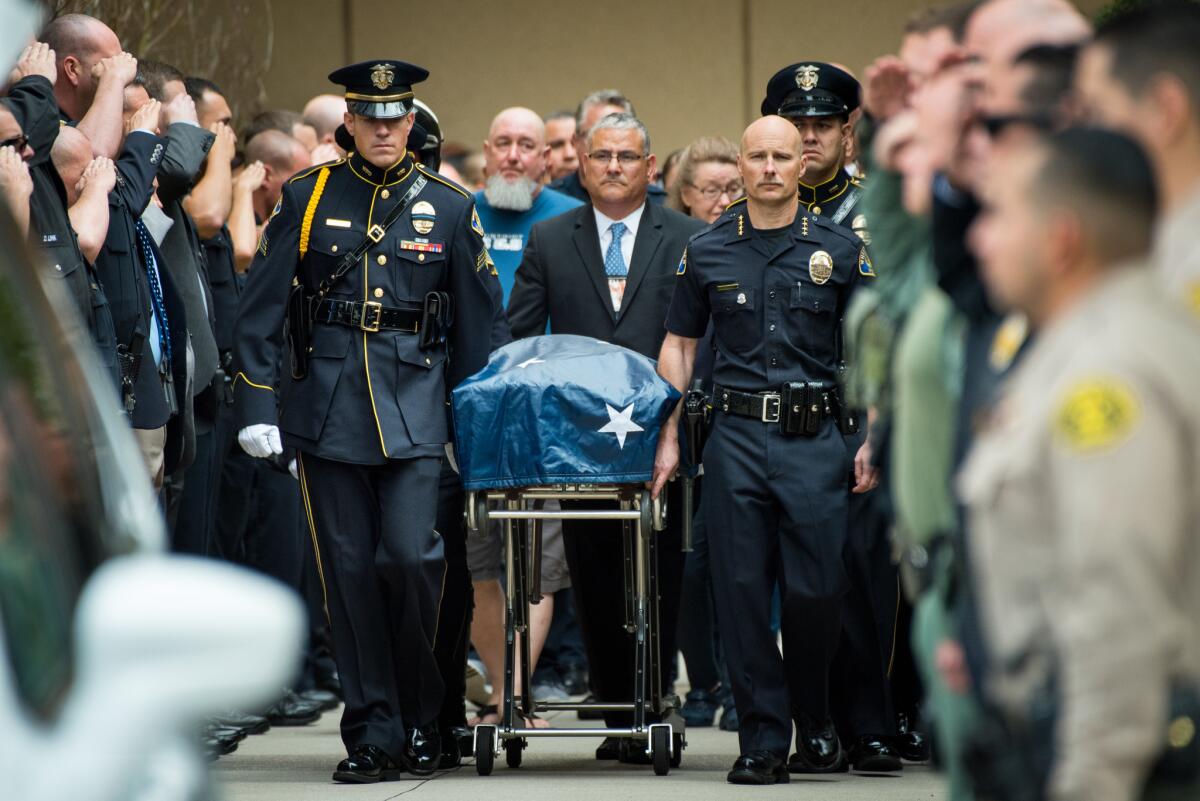 Whittier Police Chief Jeff Piper, right, and other law enforcement personnel escort the body of slain Officer Keith Boyer.
