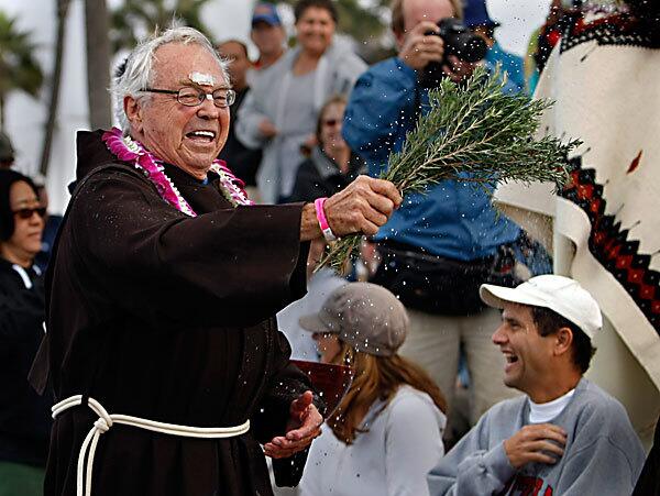 Rev Christian Mondor, 84, of Saints Simon and Jude Catholic Church in Huntington Beach participates in the Diocese of Orange's Blessing of the Waves at the Huntington Beach Pier. "The ocean is the center of our community here," said Ryan Lilyengren, a spokesman for the Roman Catholic Diocese of Orange.
