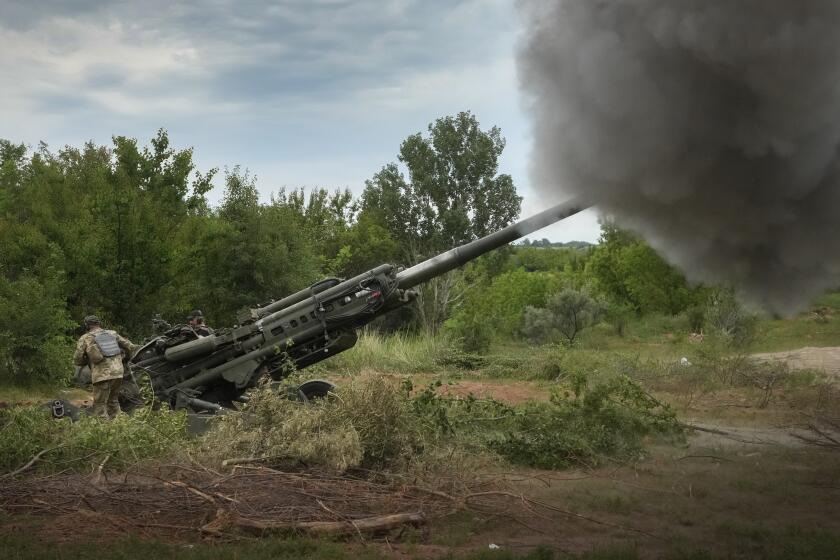 Ukrainian soldiers fire at Russian positions from a U.S.-supplied M777 howitzer in Ukraine's eastern Donetsk region Saturday, June 18, 2022. (AP Photo/Efrem Lukatsky)