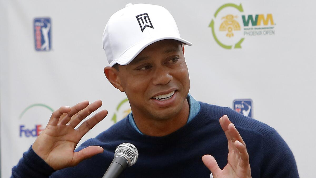Tiger Woods speaks to reporters after taking part in a Phoenix Open practice round Tuesday.