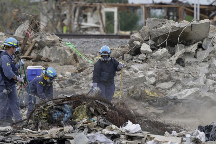 Investigators sift through the debris left by a fertilizer plant explosion in West, Texas, on May 2, 2013.