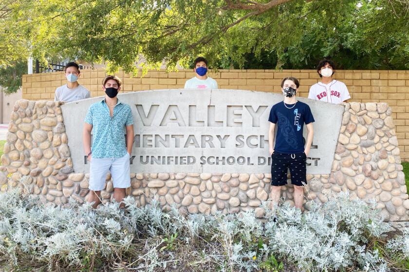 Brandon Shen, Sean Danahy, Max Anger, Drew Floyd and Juan Montano in front of their former elementary school.