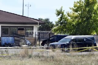 FILE - A hearse and debris can be seen at the rear of the Return to Nature Funeral Home, Oct. 5, 2023, in Penrose, Colo. (Jerilee Bennett/The Gazette via AP, File)