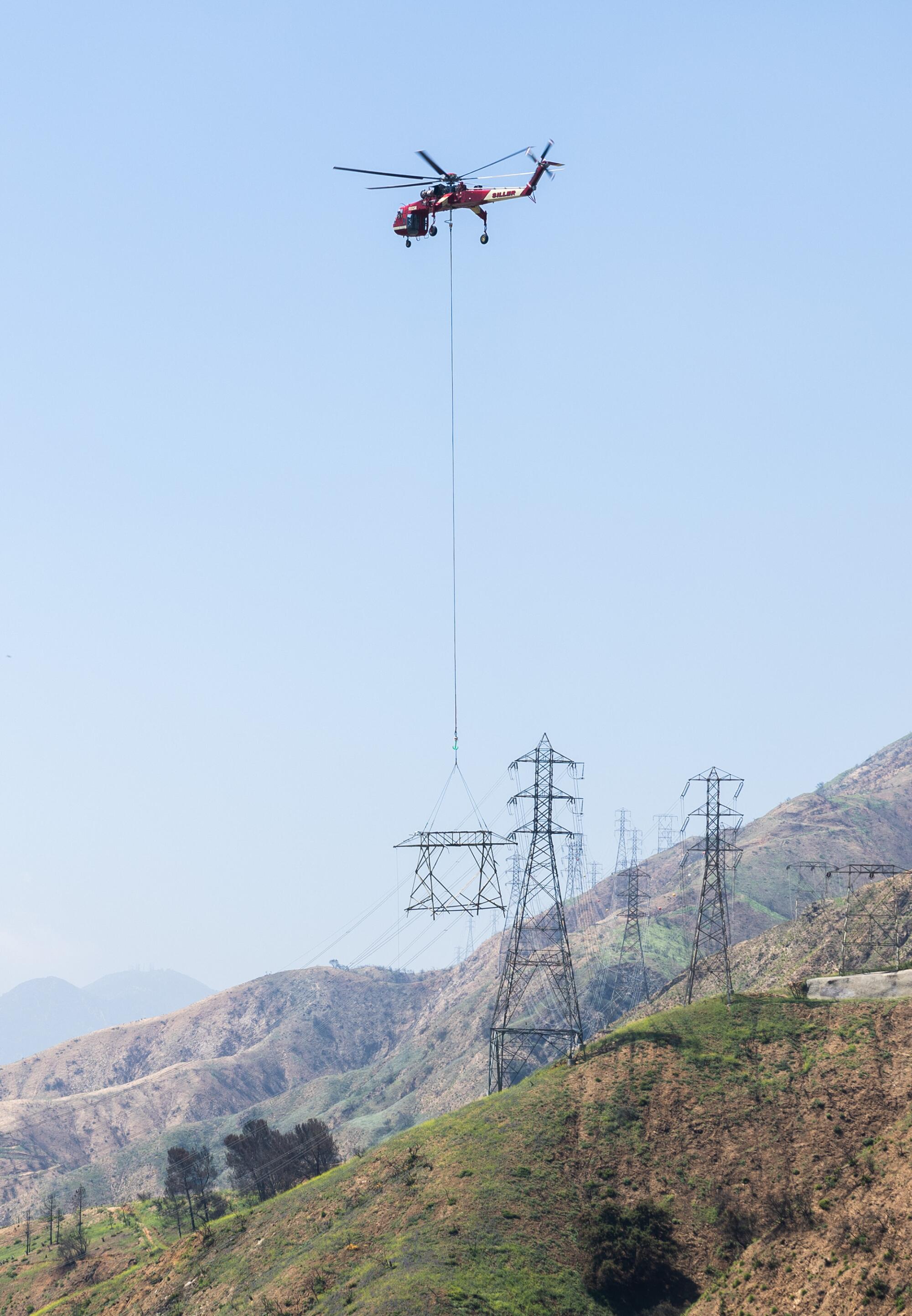 A Siller Skycrane removes Southern California Edison's Tower 208 in multiple parts from a hillside in Altadena
