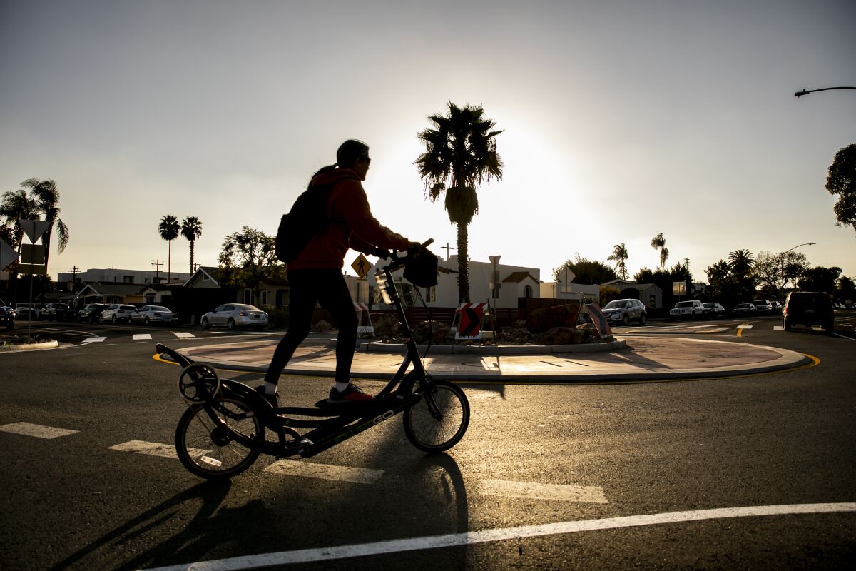A cyclist rides through a recently-built roundabout at the corner of 39th Street and Meade Avenue in Normal Heights