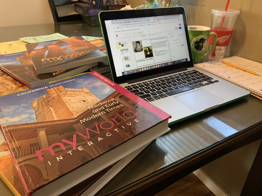 Luther Burbank Middle School teacher Stefanie Enokian set up her at-home workspace on her kitchen table. She's teaching six classes through online learning.