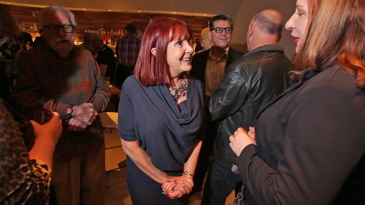 Rose Quinn, center, chats with a friend during her retirement party at Plums Cafe + Catering in Costa Mesa on Wednesday. Quinn is retiring from the Costa Mesa Chamber of Commerce after a nearly 30-year career.