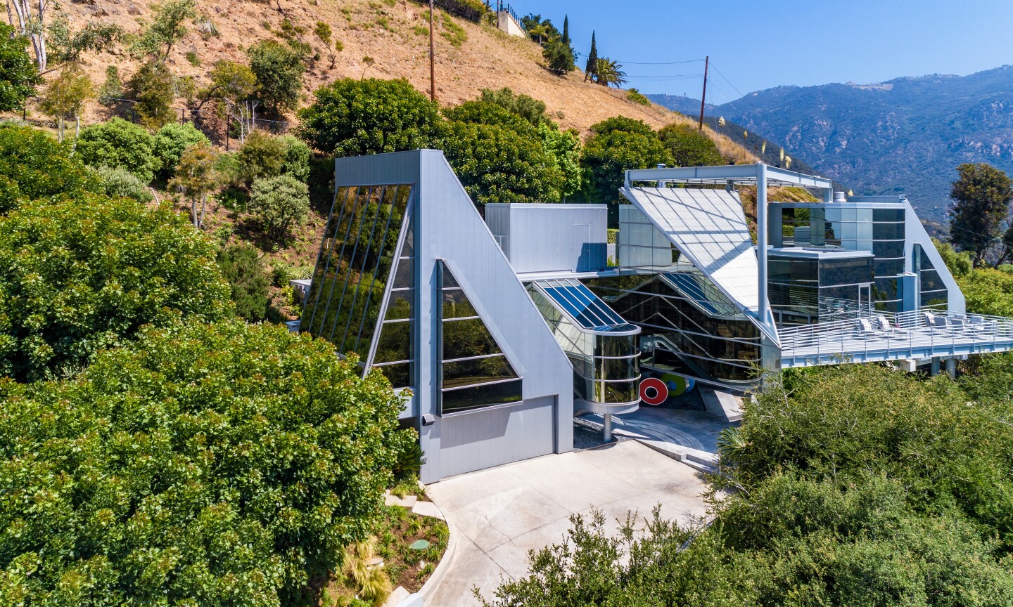 Built in 1998, the two-story home resembles a power plant with its jagged edges, glass turrets and industrial vibes.