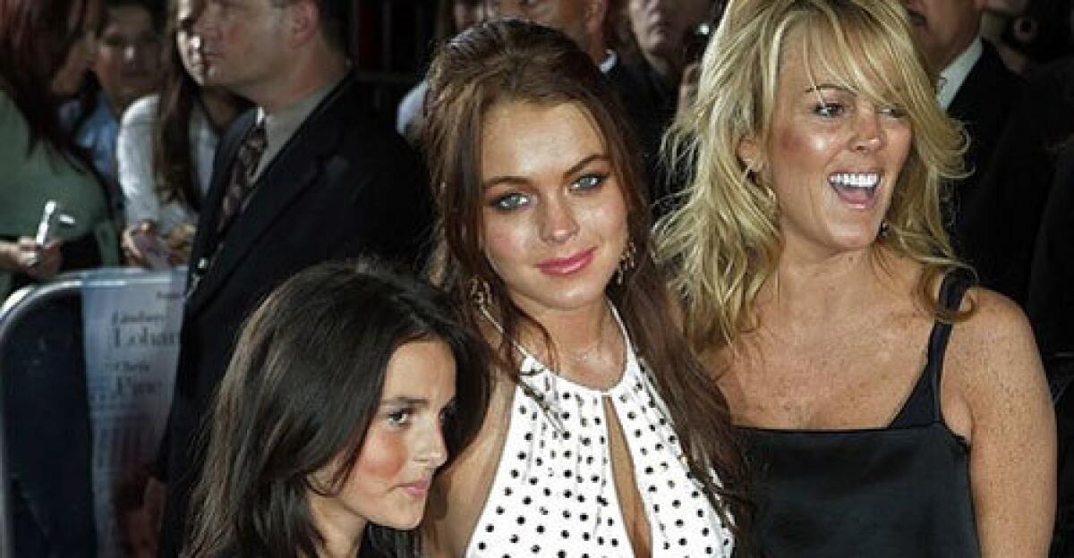 Lindsay Lohan is flanked by new reality TV stars at the premiere of her film "Just My Luck": Her sister Ali, left, and her mother, Dina.